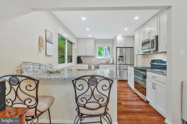 a living room with furniture a fireplace and a floor to ceiling window