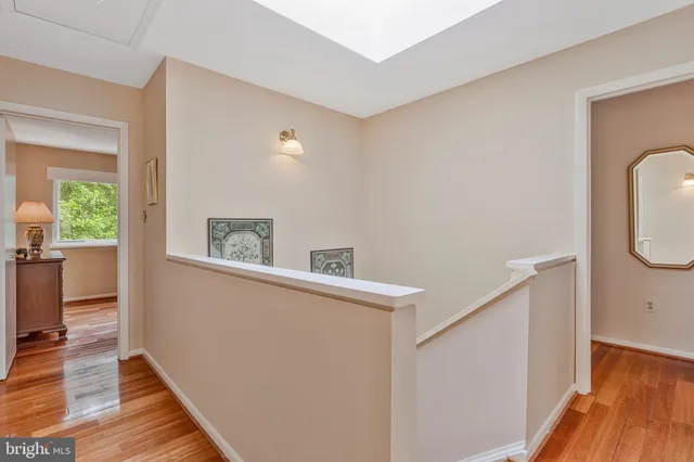 a living room with wooden floor and gym equipment