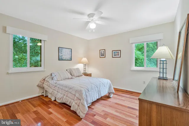 a view of hallway with wooden floor and cabinet