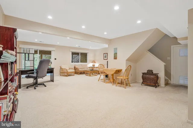 a living room with furniture a couch and potted plants