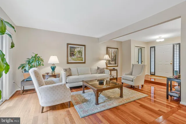 a living room with furniture kitchen view and a potted plant