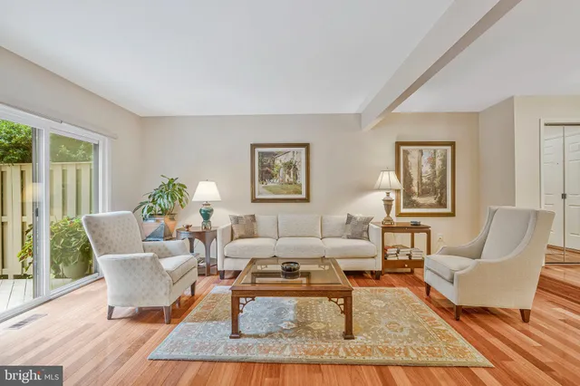 a view of a dining room with furniture a rug and wooden floor