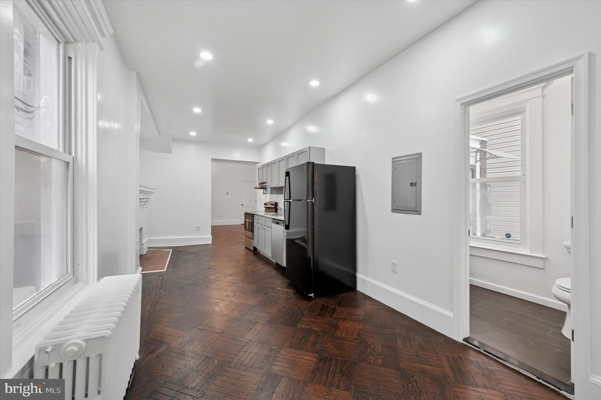 4928 Walnut Street, Unit 1 Philadelphia, PA 19139 - Photo 2 of 7 a view of a kitchen with refrigerator and wooden floor