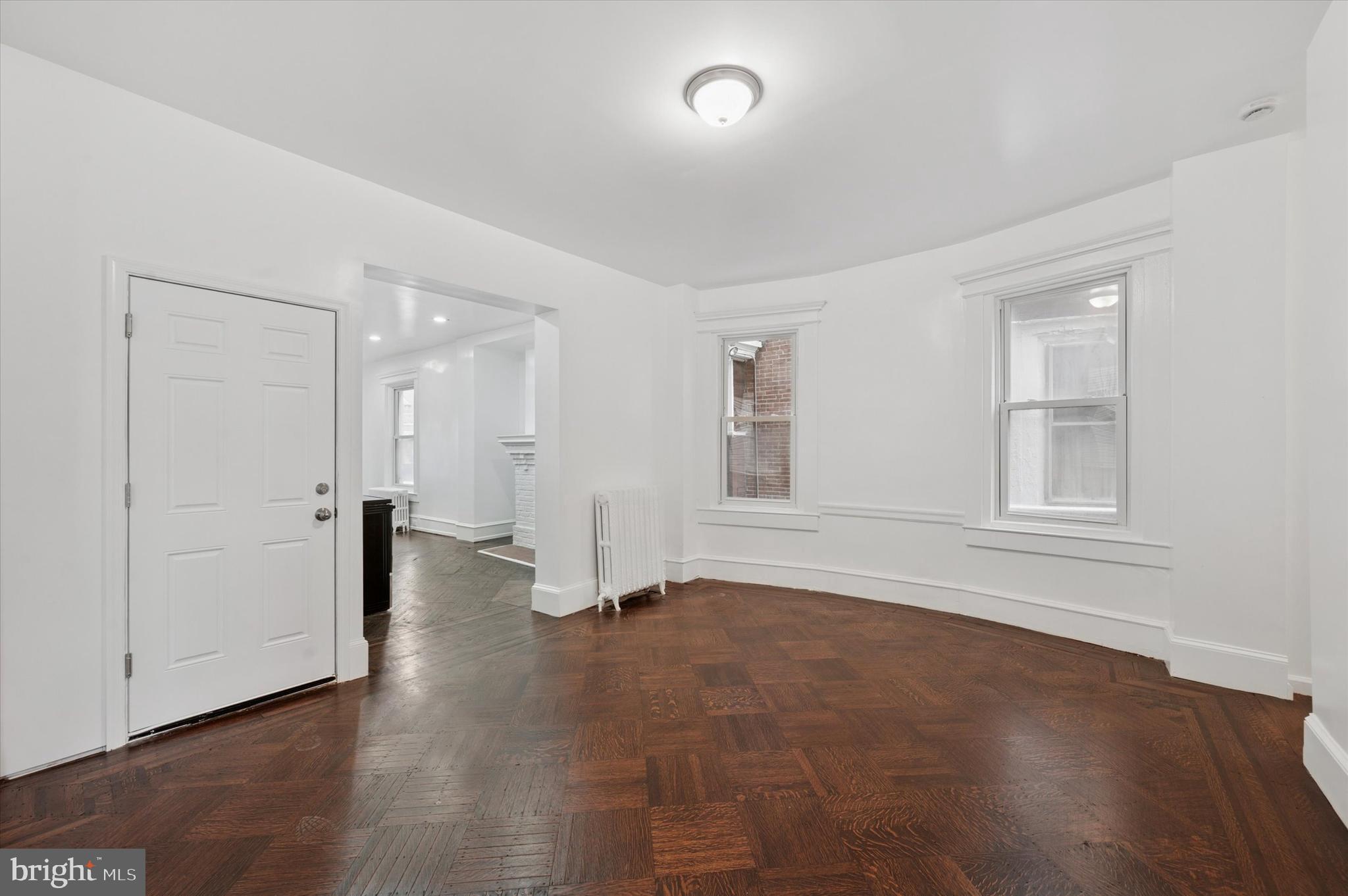 4928 Walnut Street, Unit 1 Philadelphia, PA 19139 - Photo 3 of 7 an empty room with wooden floor and windows