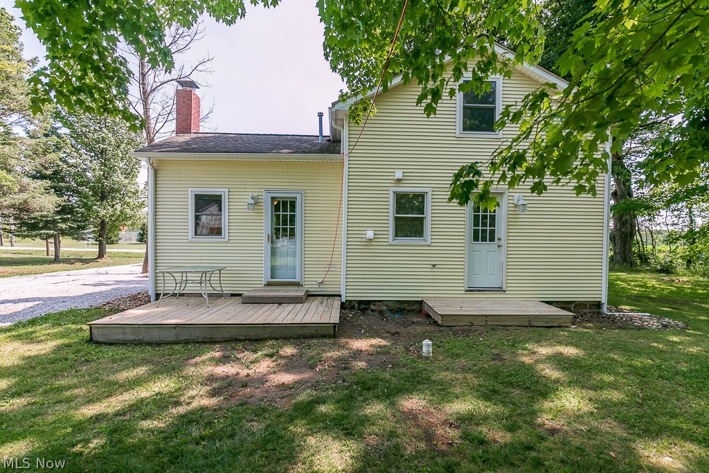16506 Leroy Thompson Road Thompson, OH 44086 - Photo 10 of 41 Rear view of property featuring a deck and a lawn