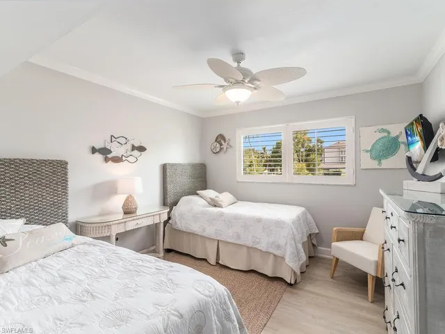 a bedroom with two beds and a large mirror