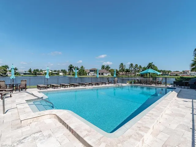 a view of a swimming pool and lounge chairs