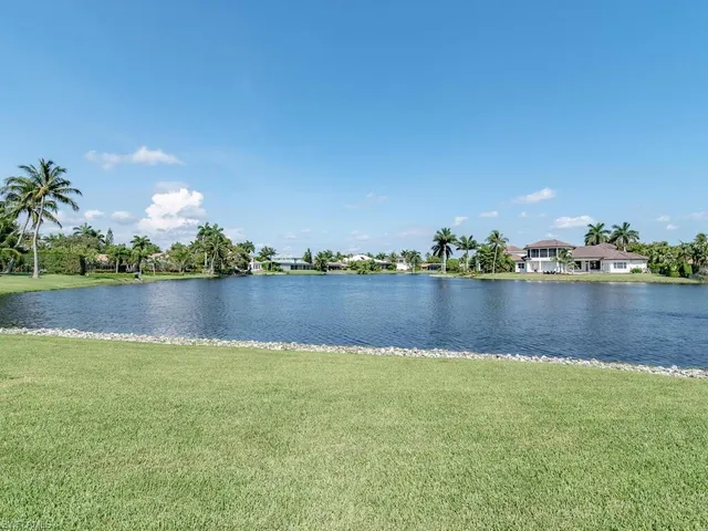 a view of a lake with houses in the background