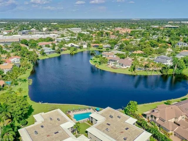an aerial view of a house with a lake view