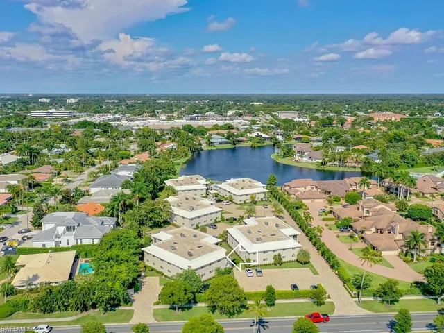 an aerial view of residential building and lake