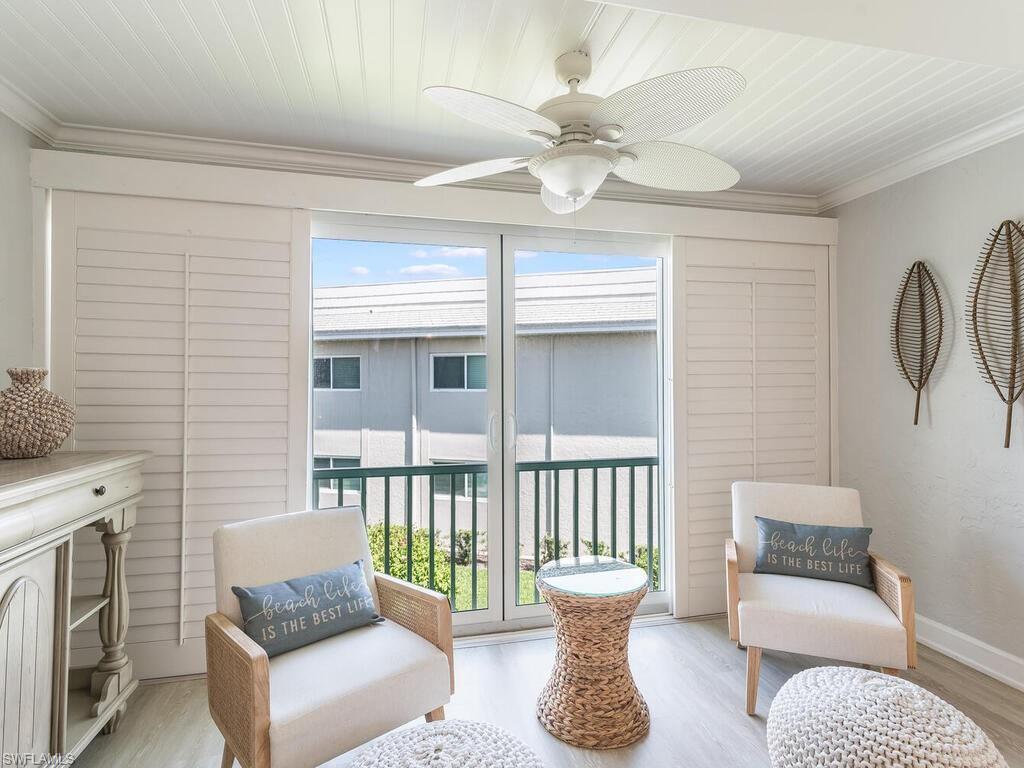 4180 Crayton Road, Unit E7 Naples, FL 34103 - Photo 5 of 35 a living room with furniture and a window