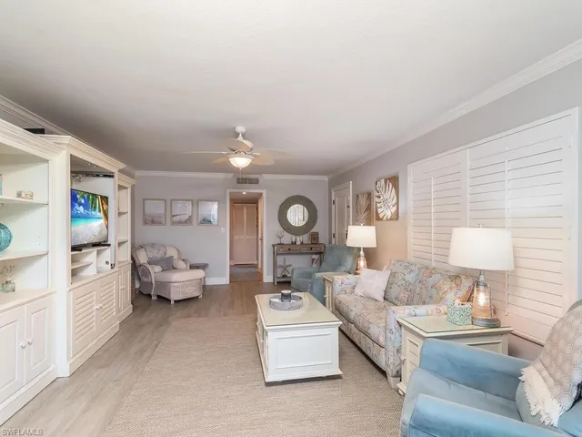 a living room with furniture and a lamp