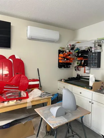 a roof deck with table and chairs under an umbrella