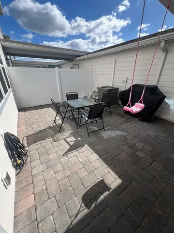a view of a swimming pool with a chair and tables