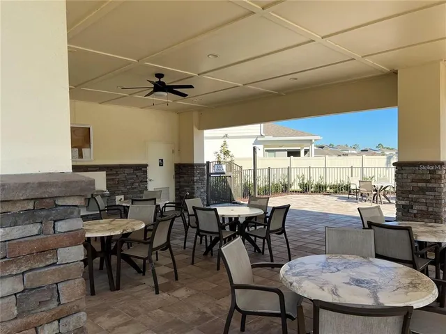 a patio with water view fountain and outdoor seating