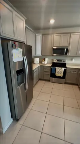 a kitchen with granite countertop a refrigerator and a sink