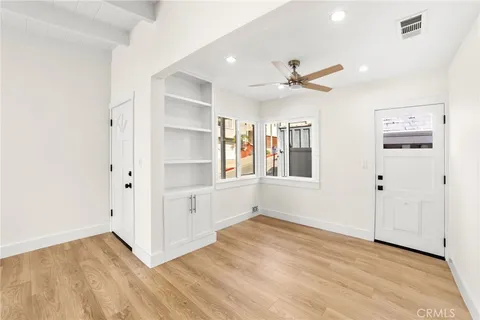 a kitchen with granite countertop a stove cabinets and a wooden floor