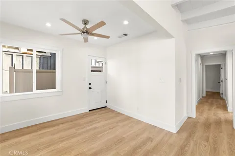 a kitchen with granite countertop white cabinets and stainless steel appliances