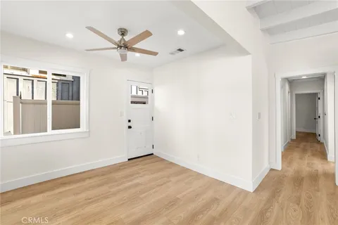 a kitchen with granite countertop white cabinets and stainless steel appliances
