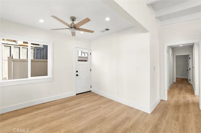 a kitchen with granite countertop white cabinets and stainless steel appliances