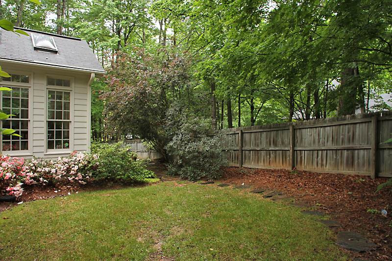 12301 Staunton Court Raleigh, NC 27613 - Photo 23 of 25 Fenced portion of backyard on the upper side of the breakfast area/room. Enter thru the fence gate and take the rock walkway around to the patio. Fenced Yard