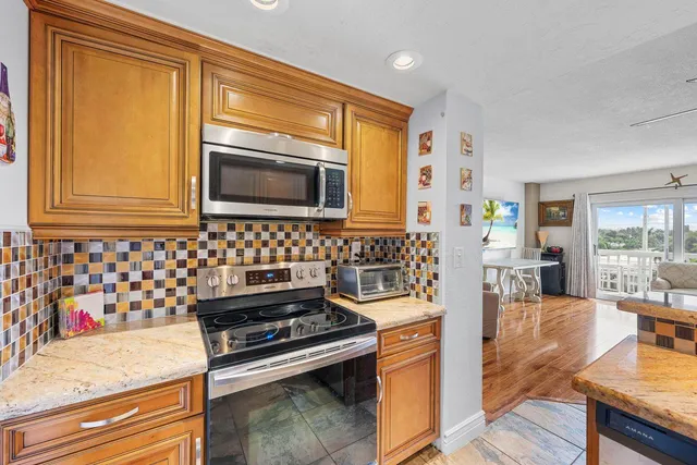 a bedroom with a bed and a flat tv screen on dresser