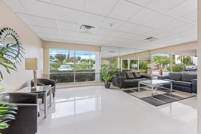 a living room with furniture and a floor to ceiling window