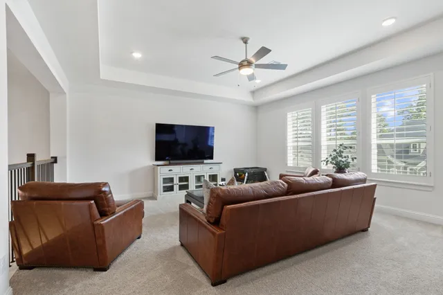 a living room with furniture a rug and a window