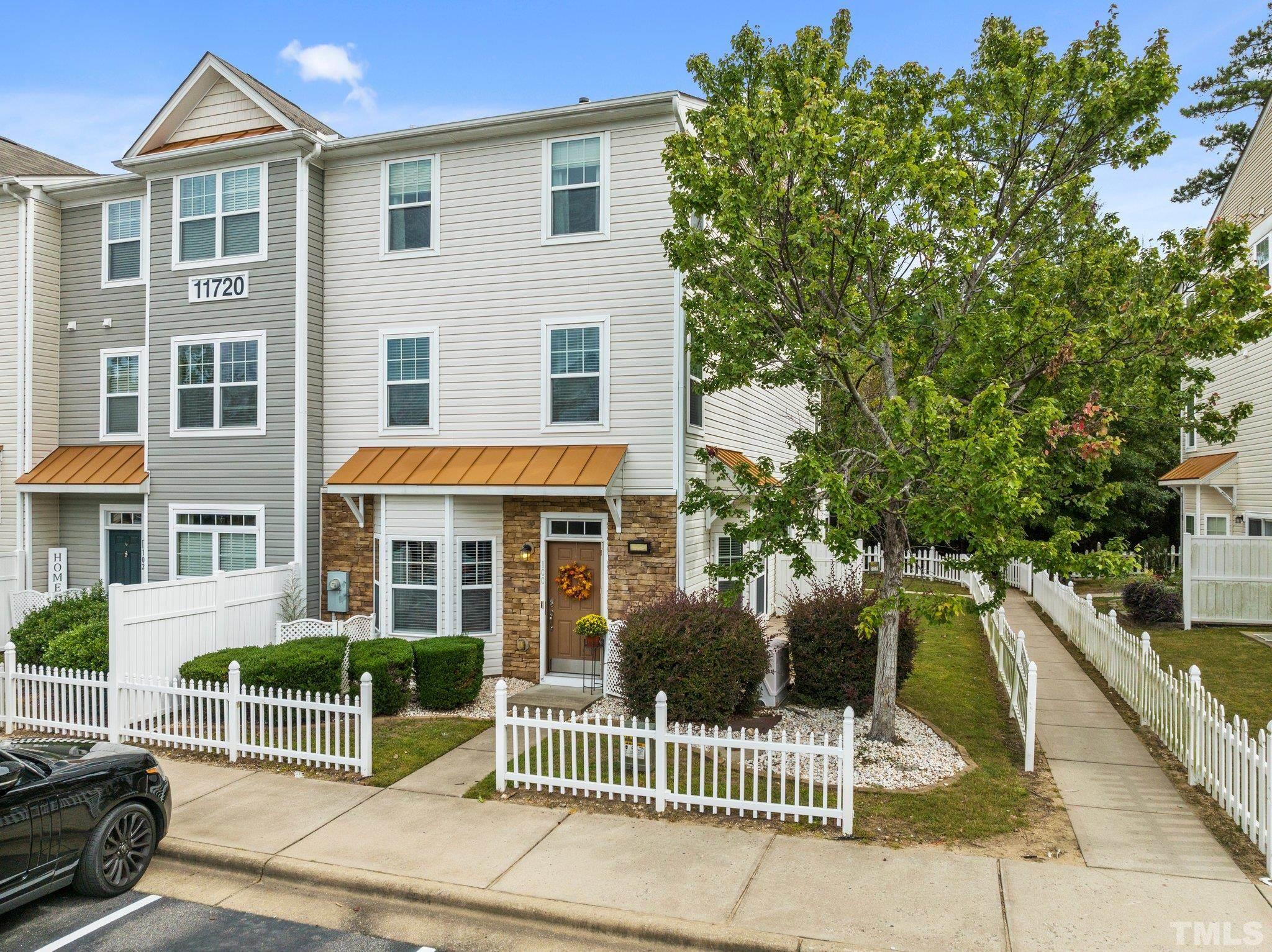 11720 Coppergate Drive, Unit 100 Raleigh, NC 27614 - Photo 1 of 22 a view of a brick house with large windows and a small yard