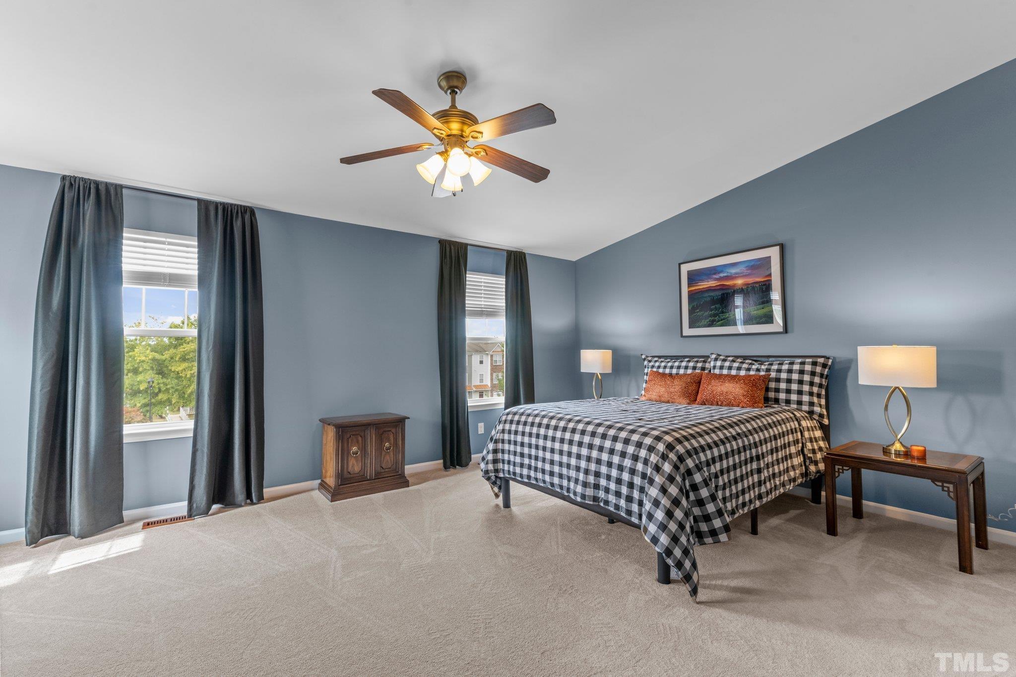 11720 Coppergate Drive, Unit 100 Raleigh, NC 27614 - Photo 11 of 22 a bedroom with a bed and a chandelier