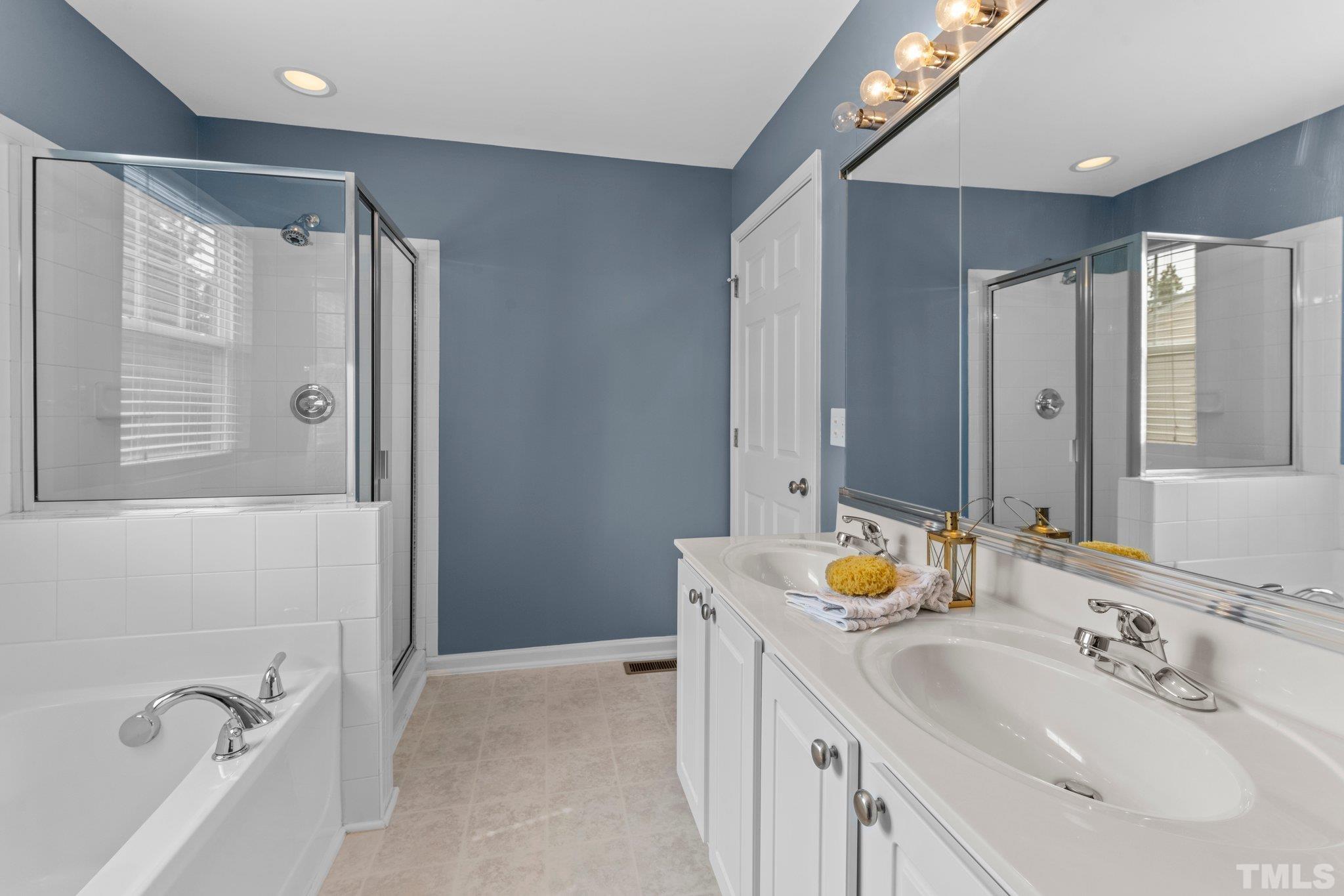 11720 Coppergate Drive, Unit 100 Raleigh, NC 27614 - Photo 12 of 22 a bathroom with a double vanity sink mirror and double
