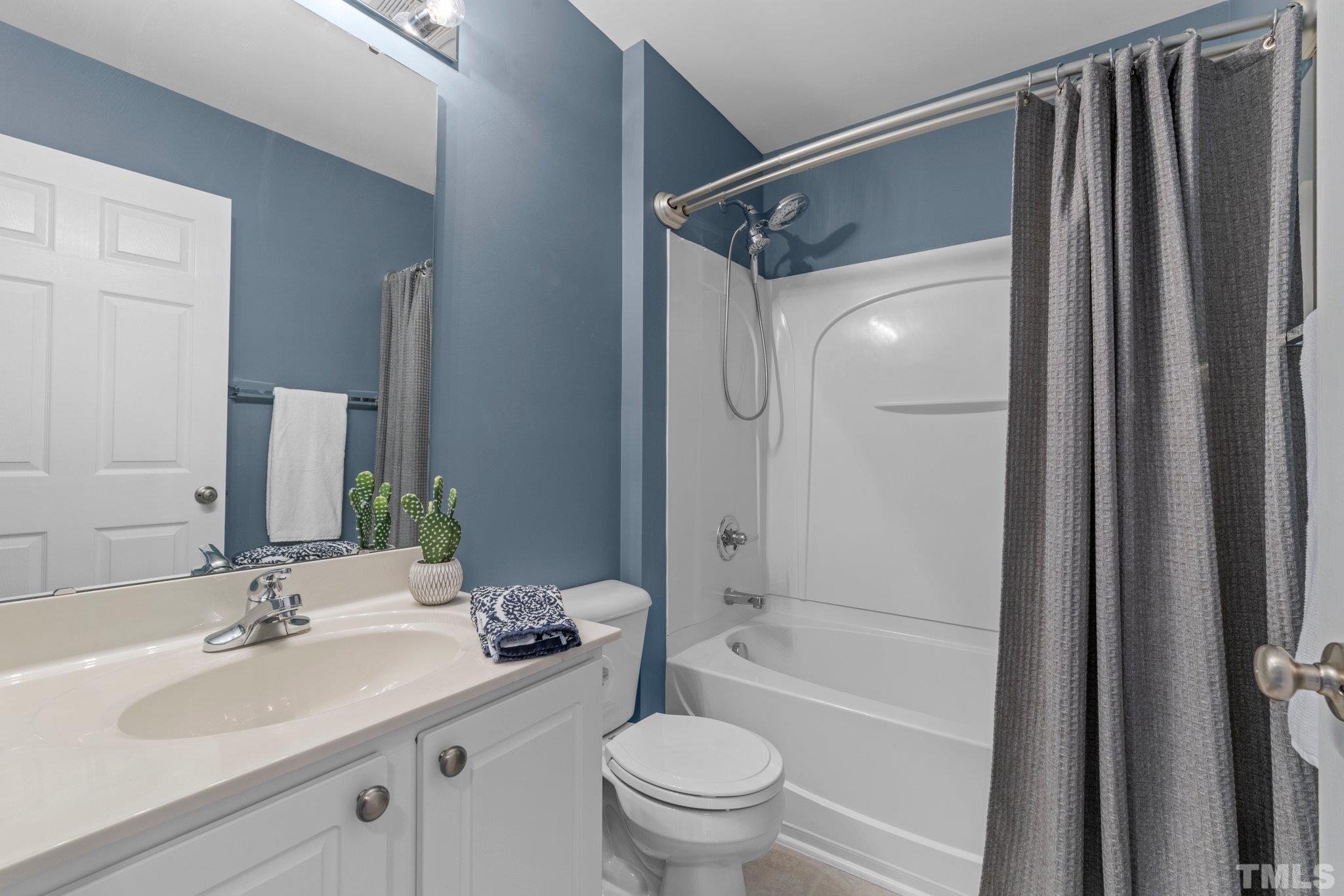 11720 Coppergate Drive, Unit 100 Raleigh, NC 27614 - Photo 15 of 22 a bathroom with a sink toilet and shower