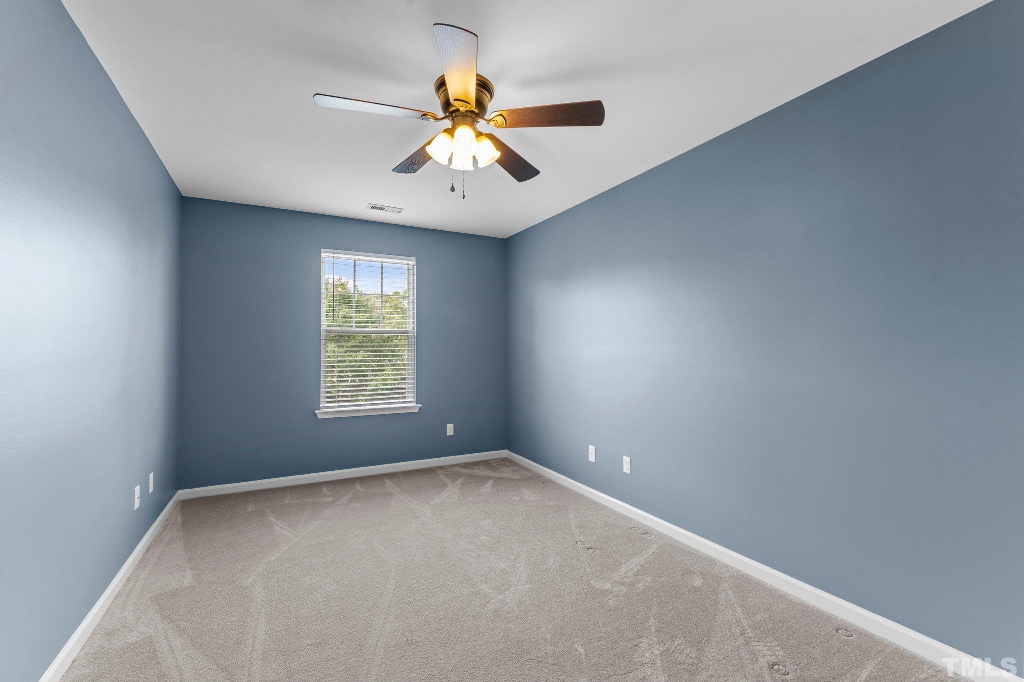 11720 Coppergate Drive, Unit 100 Raleigh, NC 27614 - Photo 16 of 22 an empty room with windows and fan