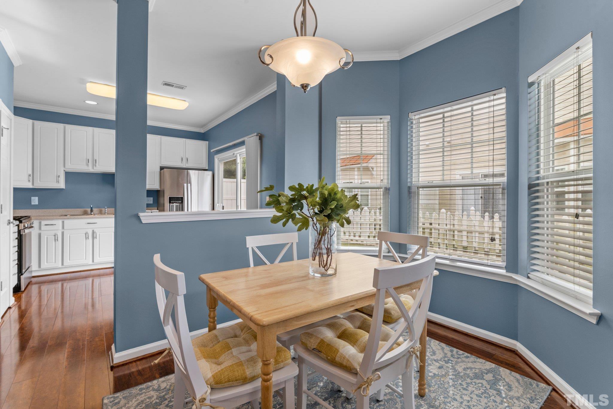 11720 Coppergate Drive, Unit 100 Raleigh, NC 27614 - Photo 4 of 22 a dining room with wooden floor and chandelier