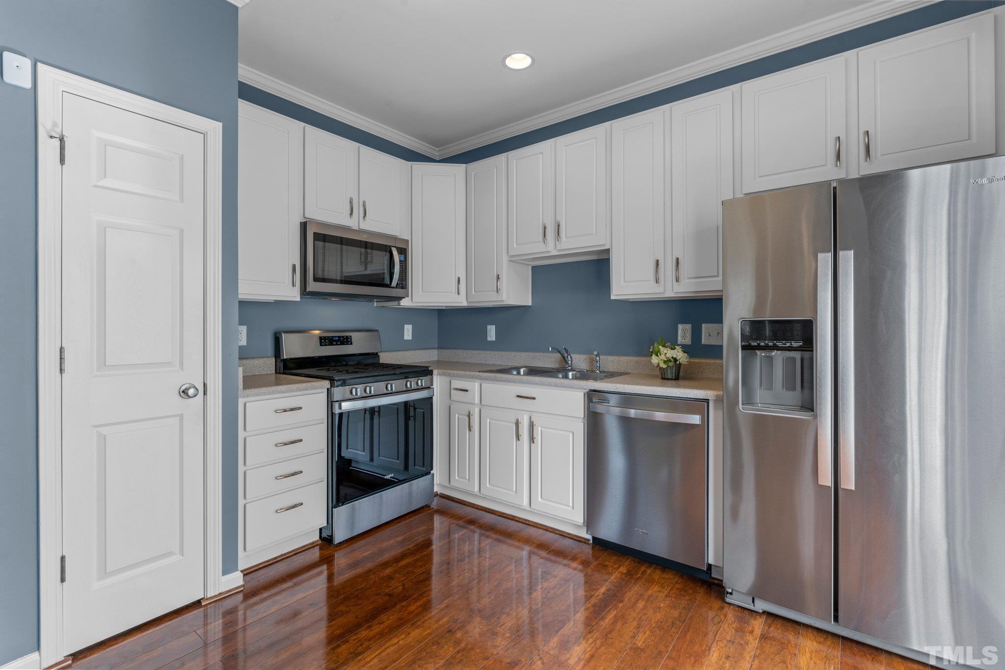 11720 Coppergate Drive, Unit 100 Raleigh, NC 27614 - Photo 6 of 22 a kitchen with granite countertop white cabinets and stainless steel appliances