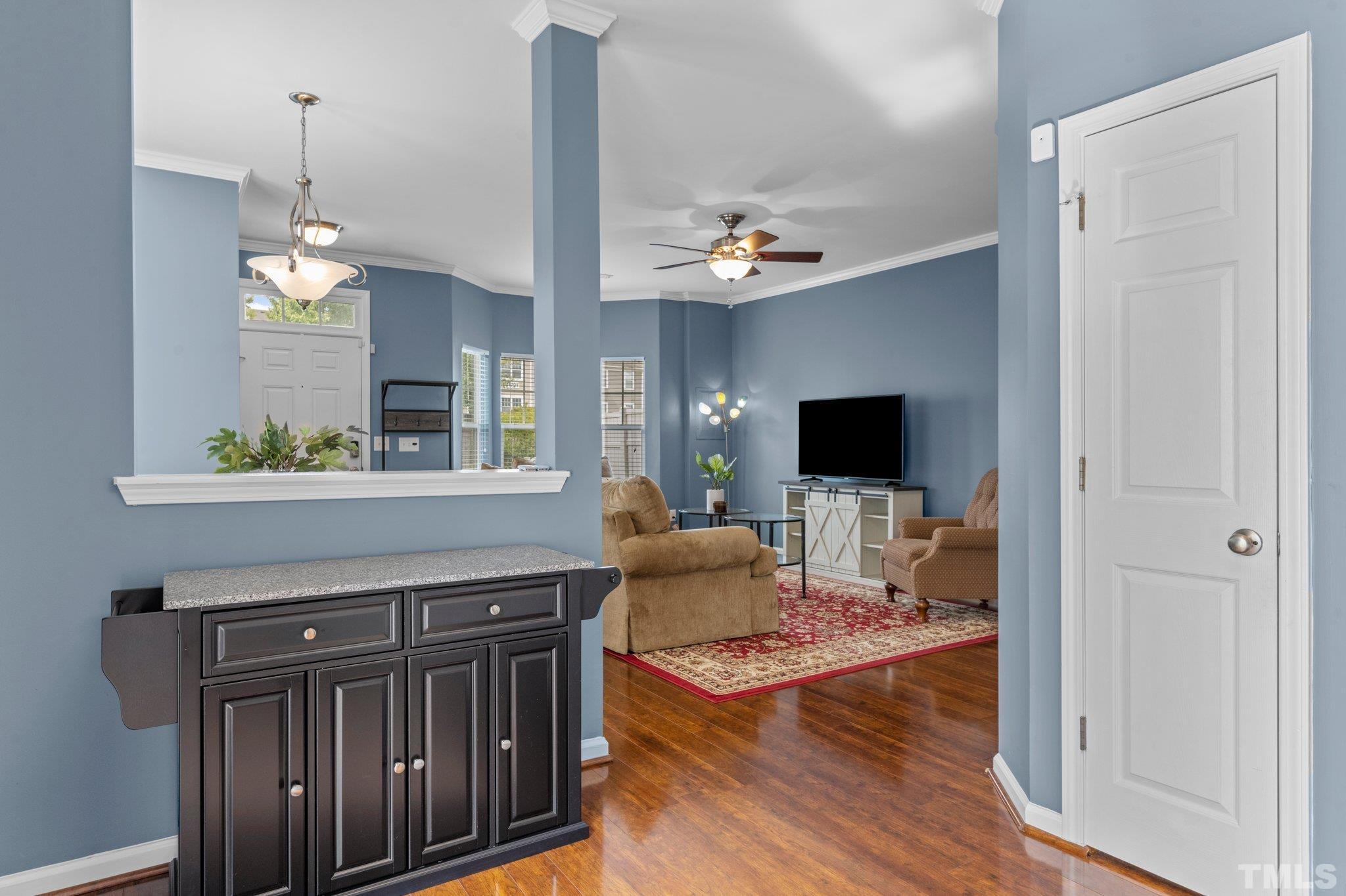 11720 Coppergate Drive, Unit 100 Raleigh, NC 27614 - Photo 8 of 22 a view of a livingroom with furniture wooden floor and a chandelier