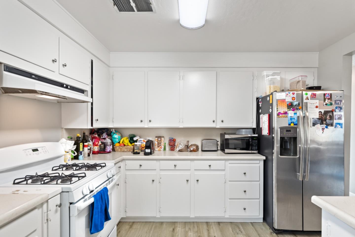 1010 Williams Way Mountain View, CA 94040 - Photo 8 of 26 a kitchen with stainless steel appliances a white stove top oven and cabinets