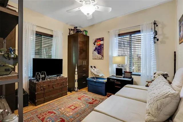 an aerial view of residential houses with outdoor space and trees