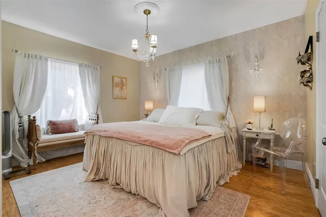 an aerial view of a house with a yard and large trees