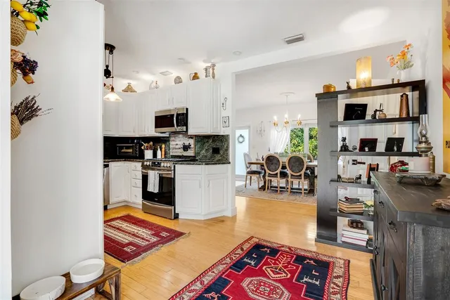 a spacious bedroom with a bed and a chandelier