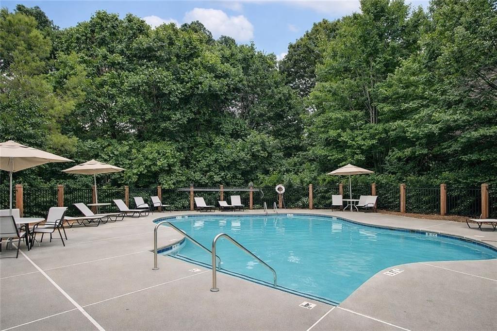 765 Trevett Way Marietta, GA 30066 - Photo 36 of 44 a view of a patio with a table and chairs under an umbrella