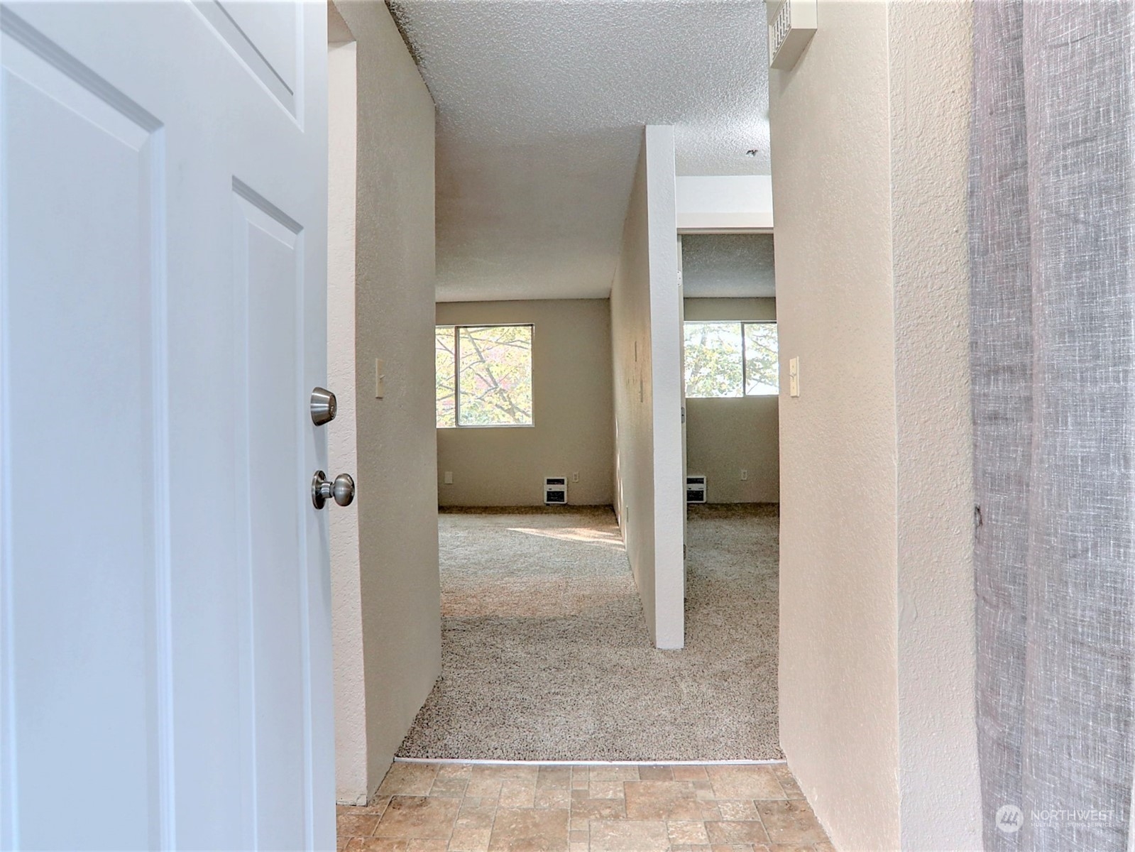 2629 Rucker Avenue, Unit 6 Everett, WA 98201 - Photo 3 of 14 a view of a hallway with wooden floor and a bathroom