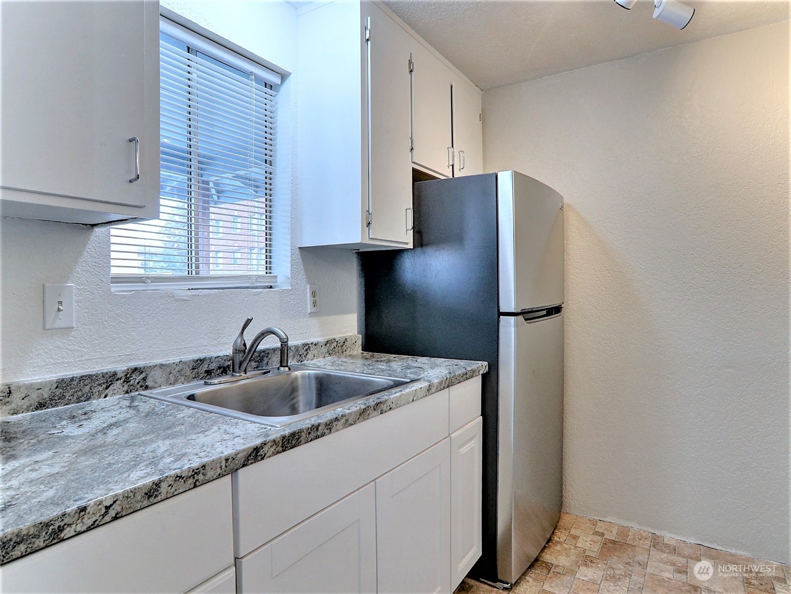 2629 Rucker Avenue, Unit 6 Everett, WA 98201 - Photo 4 of 14 a kitchen with stainless steel appliances granite countertop a sink a refrigerator and a stove