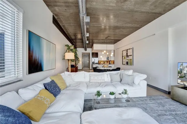 a living room with furniture and a potted plant
