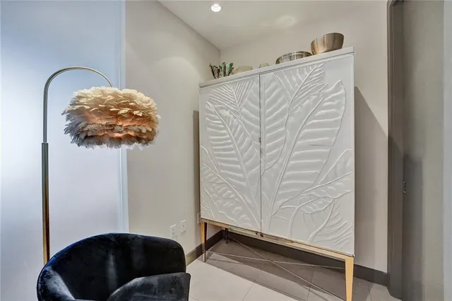 a bedroom with a bed and glass walk in closet