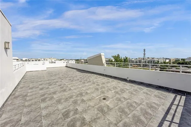 a view of a terrace with a table and chairs