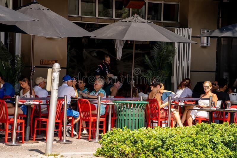 110 Southeast 2nd Street, Unit 402 Delray Beach, FL 33444 - Photo 44 of 49 a group of people sitting outside of a house