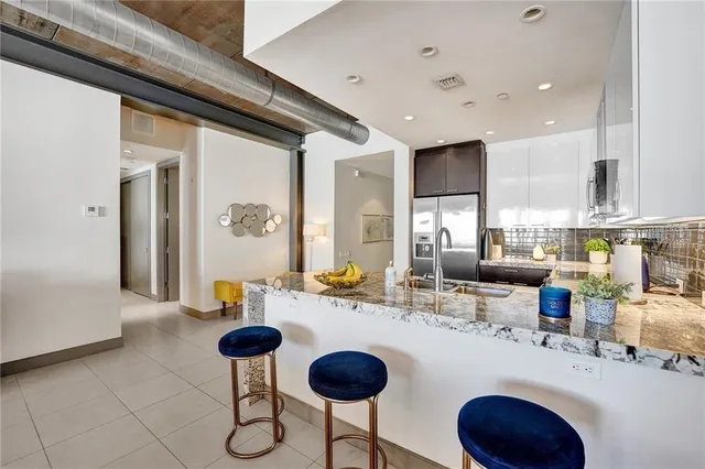 a kitchen with dining table and chairs