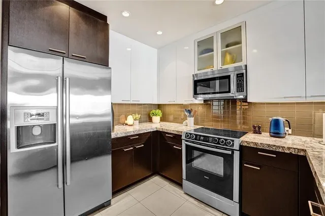 a kitchen with a refrigerator sink and microwave