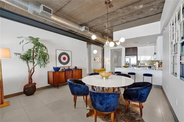 a outdoor dining space with furniture and a chandelier